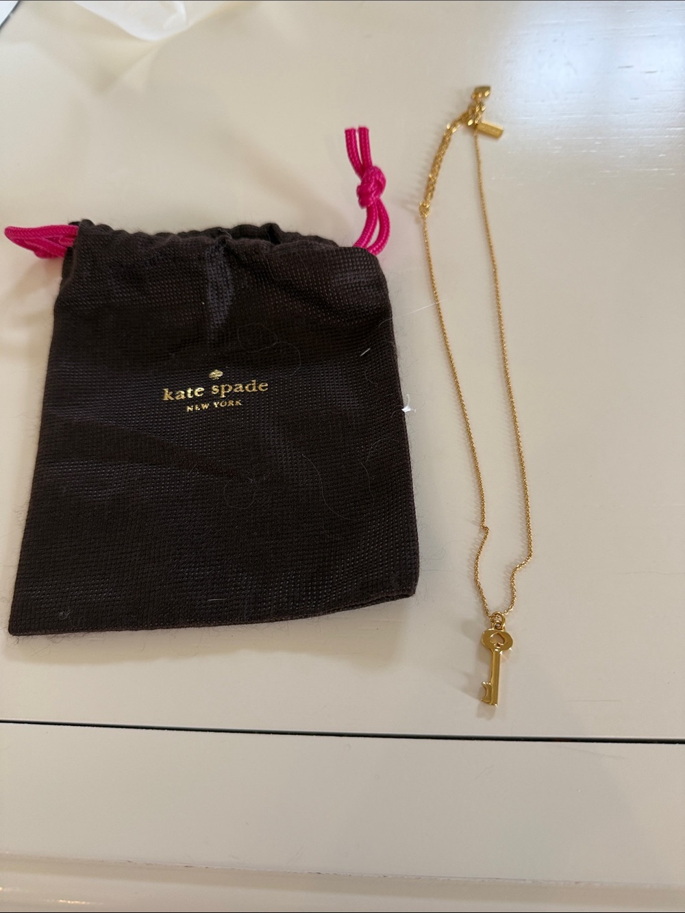 kate spade Gold Key Pendant Necklace with Black Pouch and Pink Drawstring